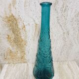Blue pressed glass bottle decorated with flowers