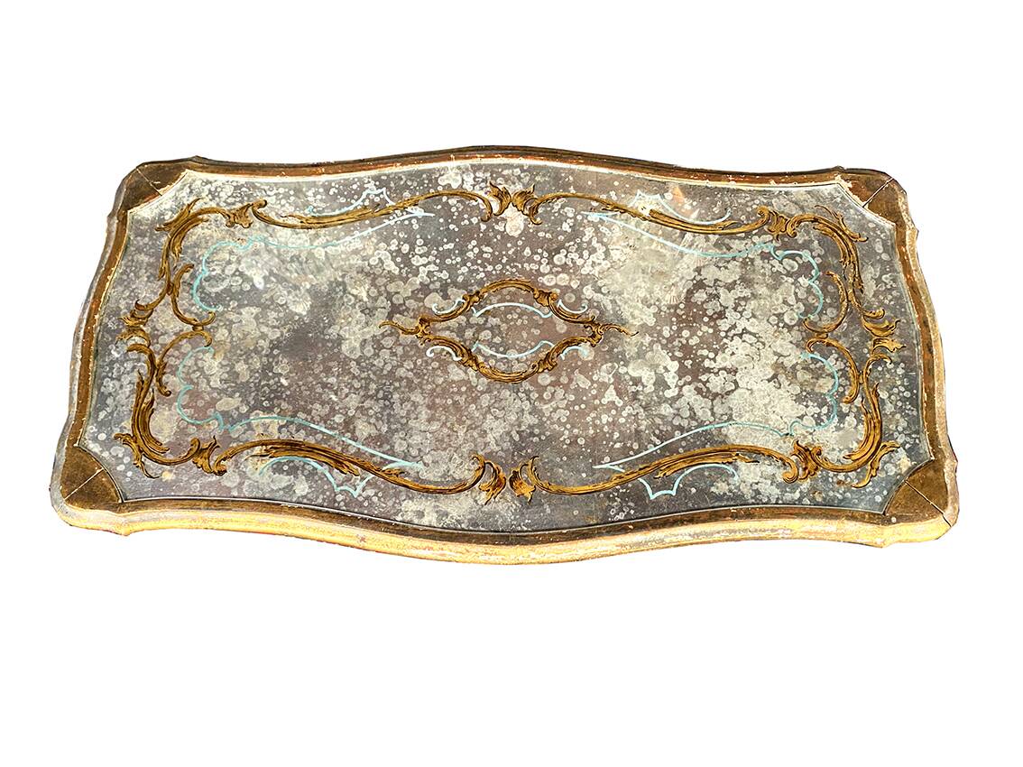 Louis XV style coffee table in carved wood with grey and gold highlights.