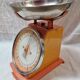 Orange metal household scale from 1970