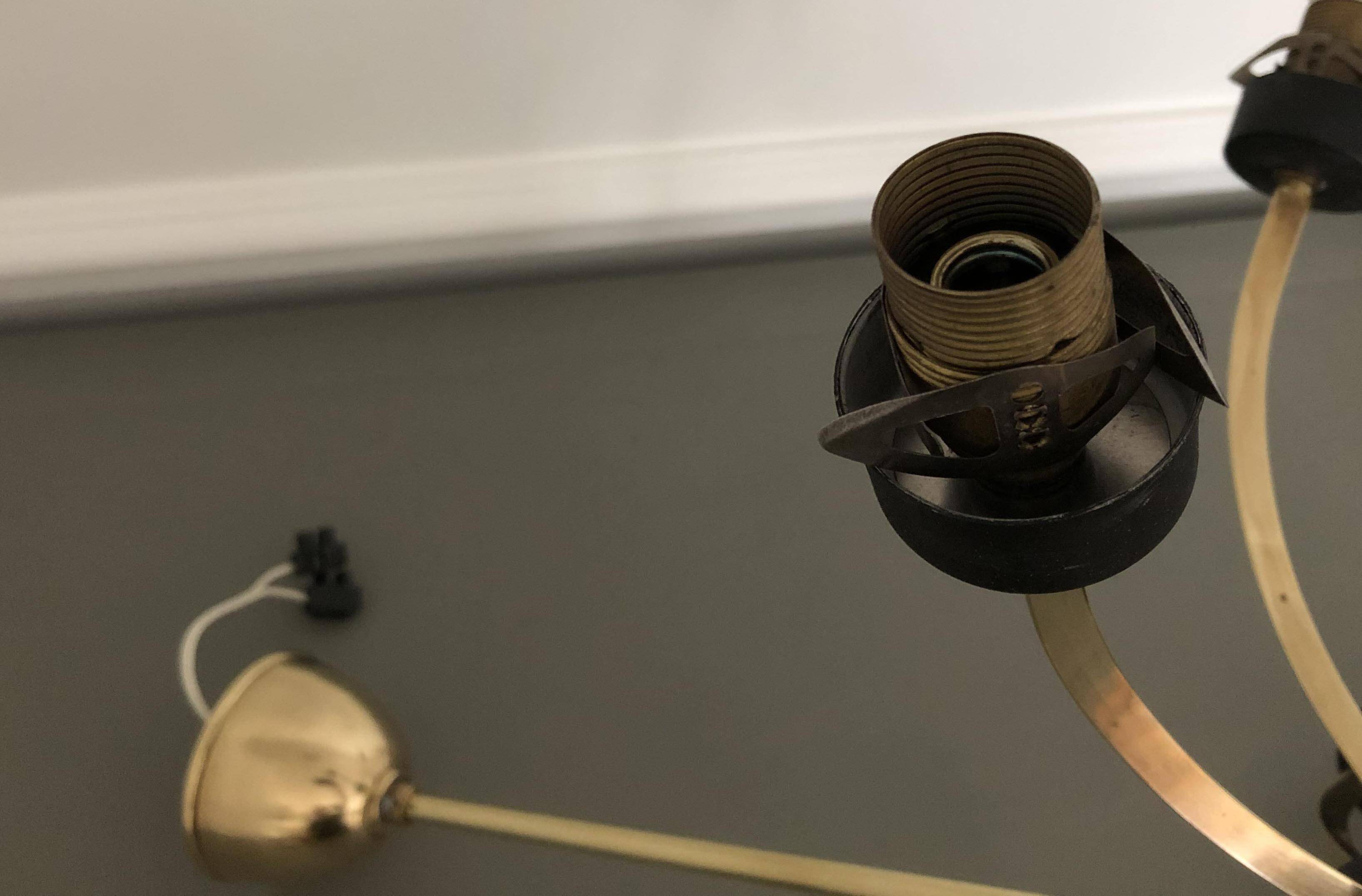 Lustre with 5 branches from the 1960s - 1970s in solid brass and black metal.