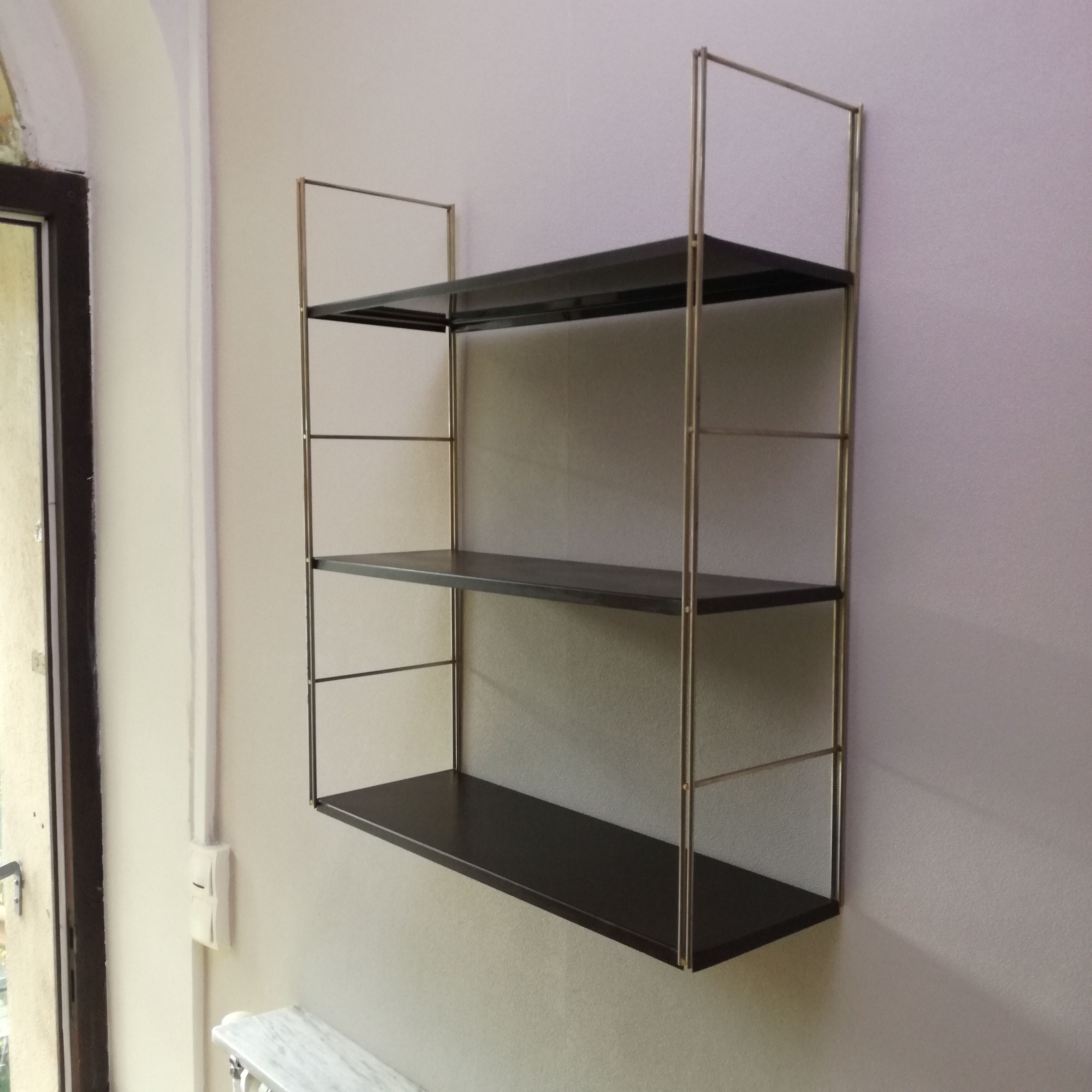 Golden and brown stringed shelf in metal