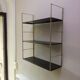 Golden and brown stringed shelf in metal