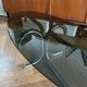 Table basse design ovale années 70 en verre fumé noir et pieds chromé