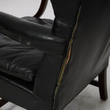 Pairs of black leather Scandinavian armchairs