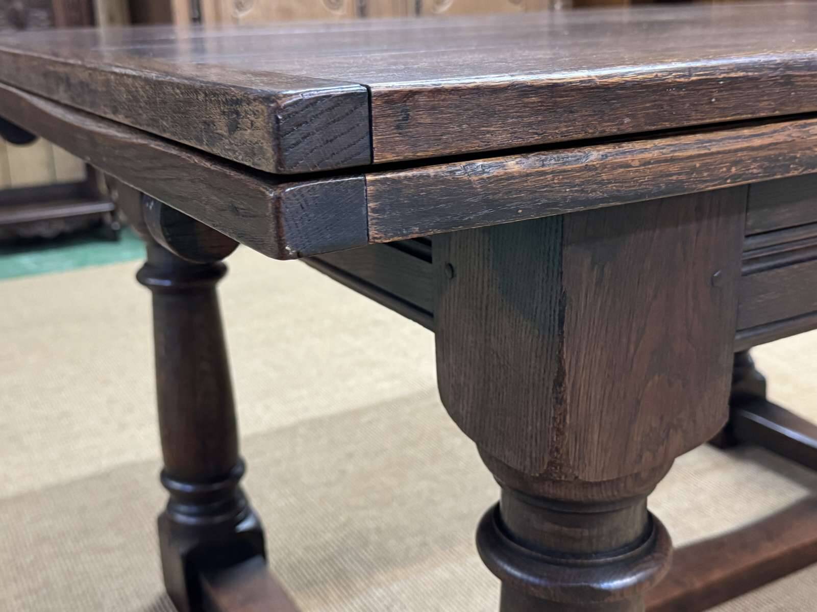 English monastery table with extensions from the late 19th century in elm and oak.