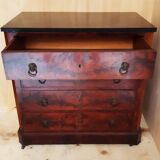 Antique chest of drawers with mahogany veneer and lion heads