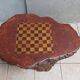Brutalist chessboard coffee table made from tree stump.