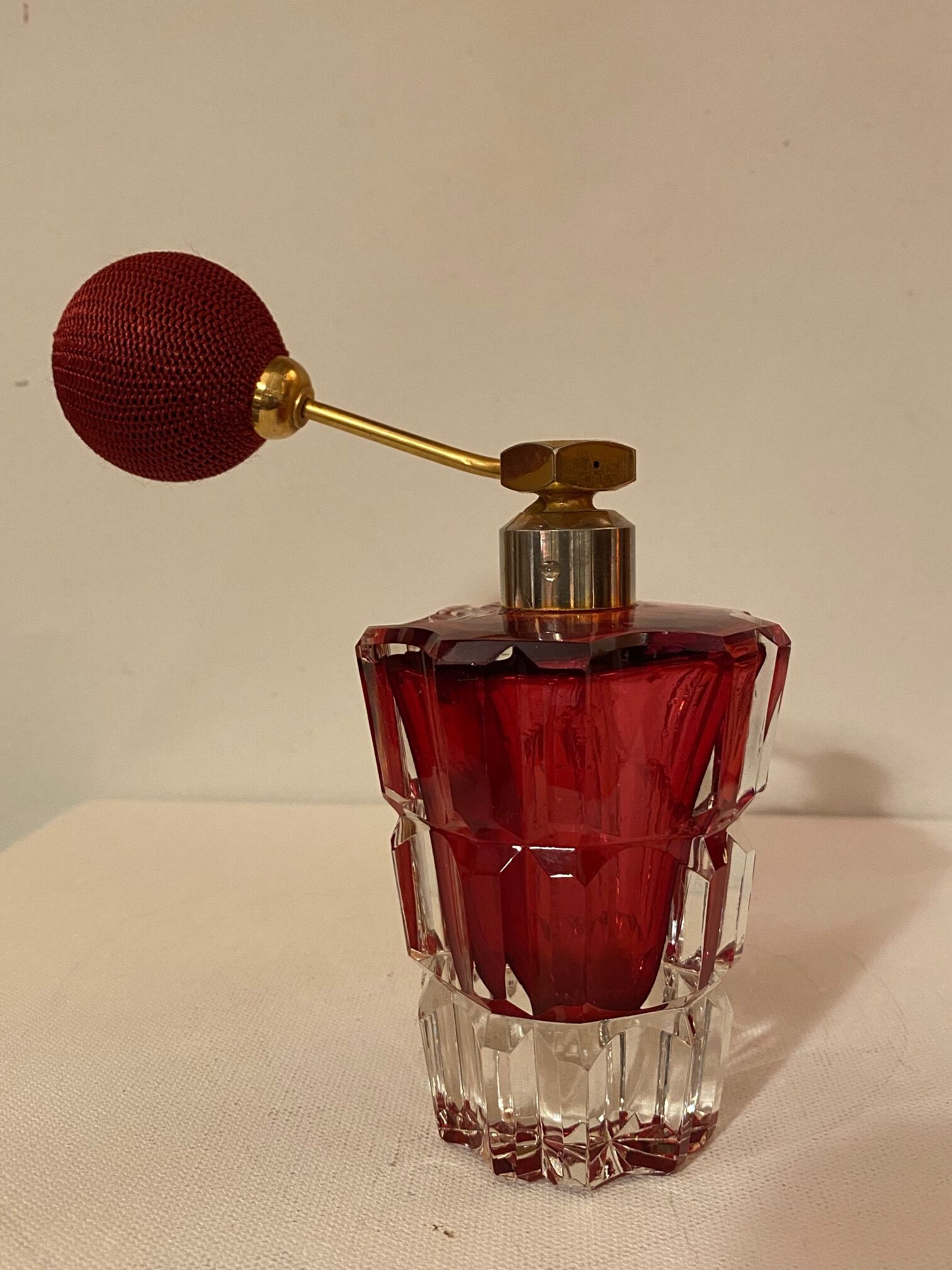 Red crystal perfume spray and red pump.