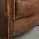 Sheepskin clubarmchair with beautiful patina finished with decorative nails