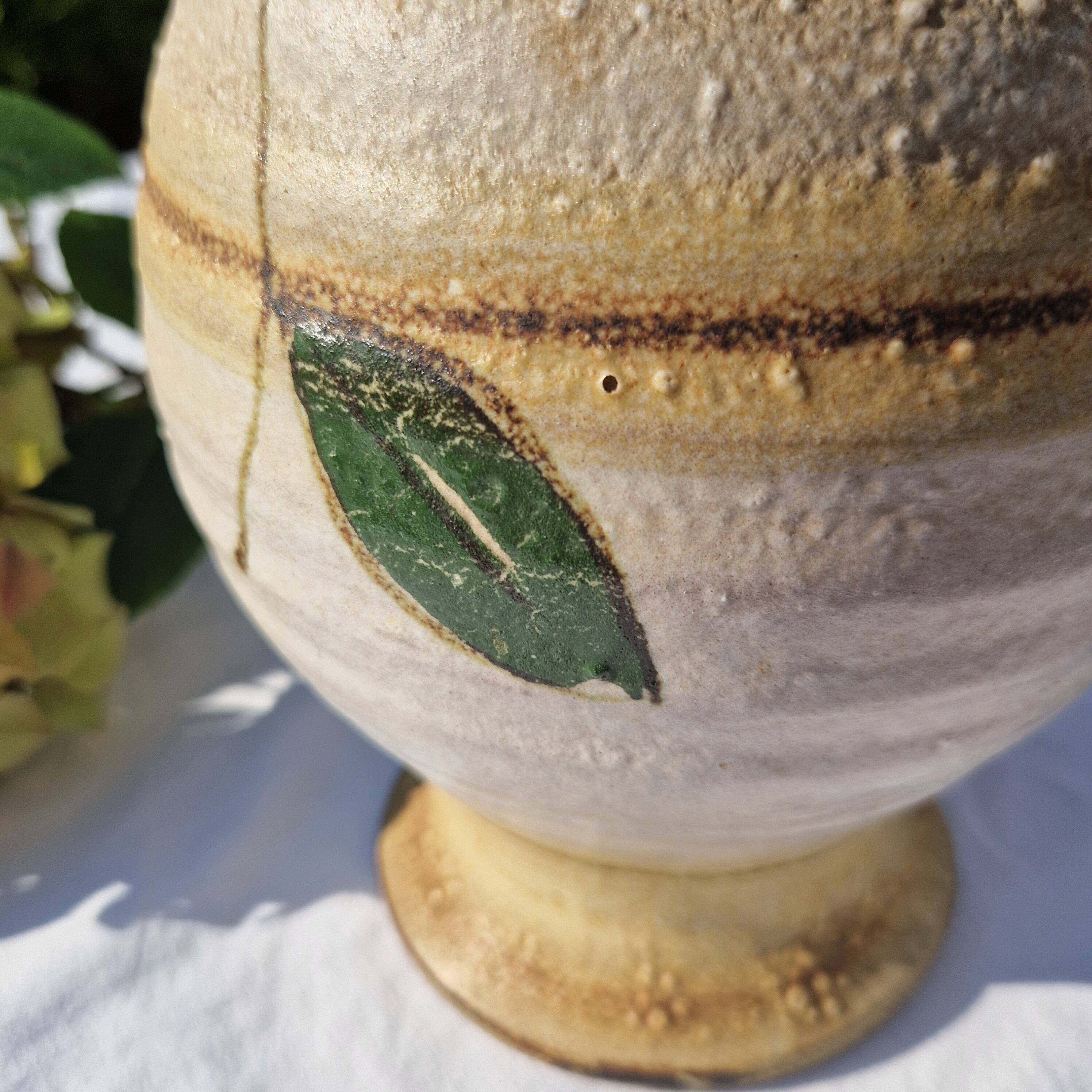 Handcrafted jug or jar with a handle, terracotta pottery vase, fat lava effect, stylized flowers