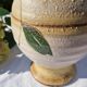 Handcrafted jug or jar with a handle, terracotta pottery vase, fat lava effect, stylized flowers