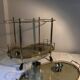 Neoclassical bar cart in gilded brass and smoked glass