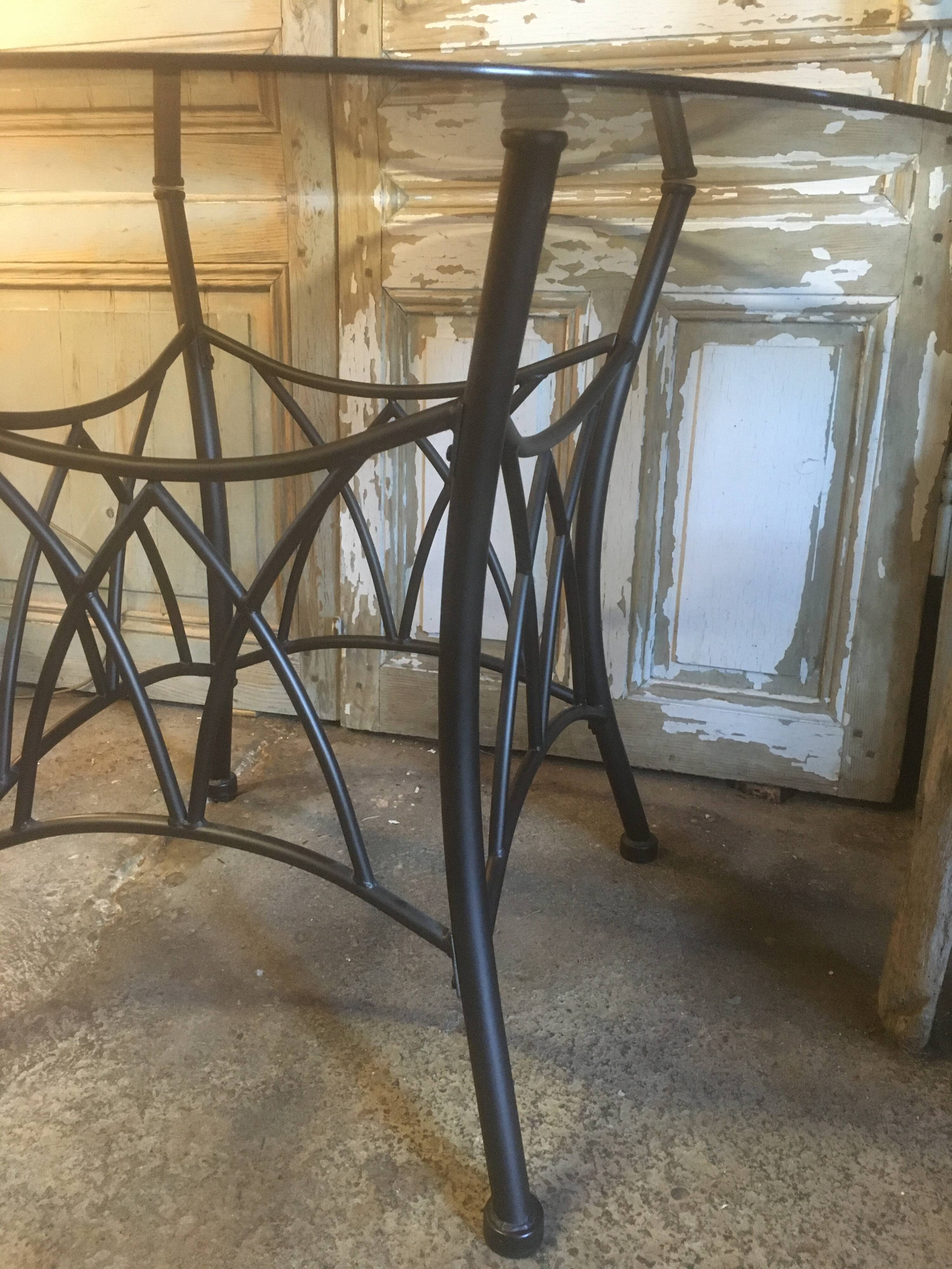 Round table with metal legs and smoked glass