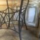 Round table with metal legs and smoked glass.