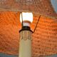 Large wooden lamp with a woven rattan shade.