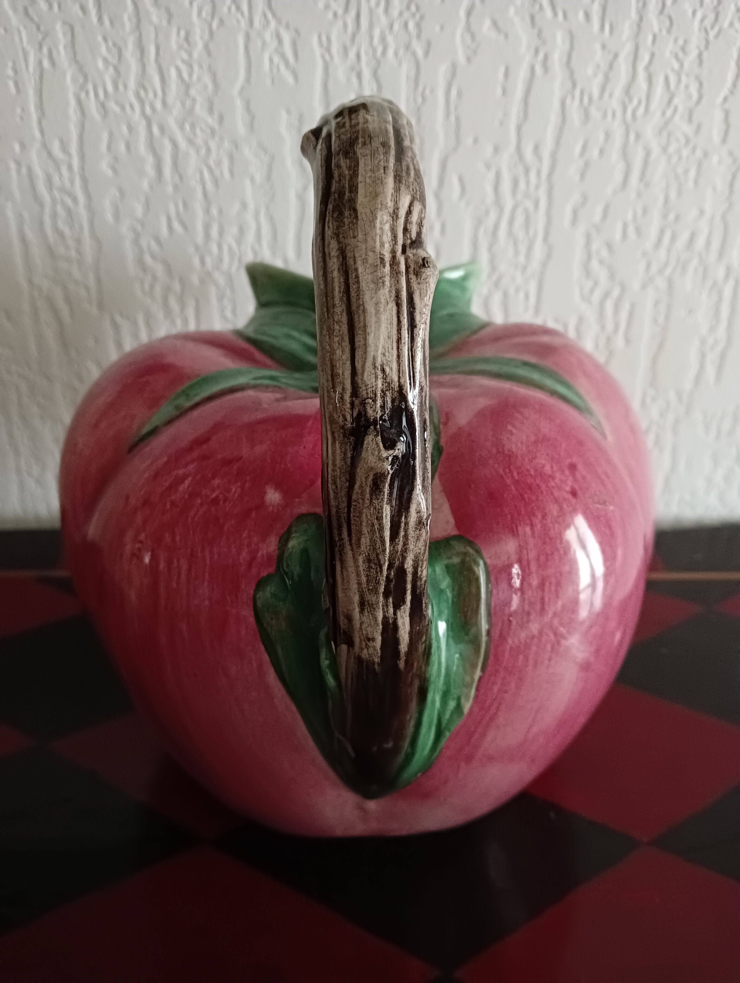 Pink pitcher in the shape of a strawberry, Italian slurry.