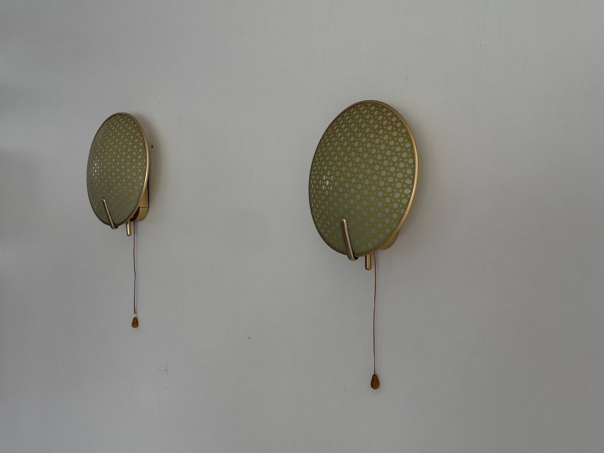 Pair of green plexiglass and gold metal wall lights by Erco, 1950s, Germany.