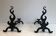 Pair of andirons in cast iron and wrought iron