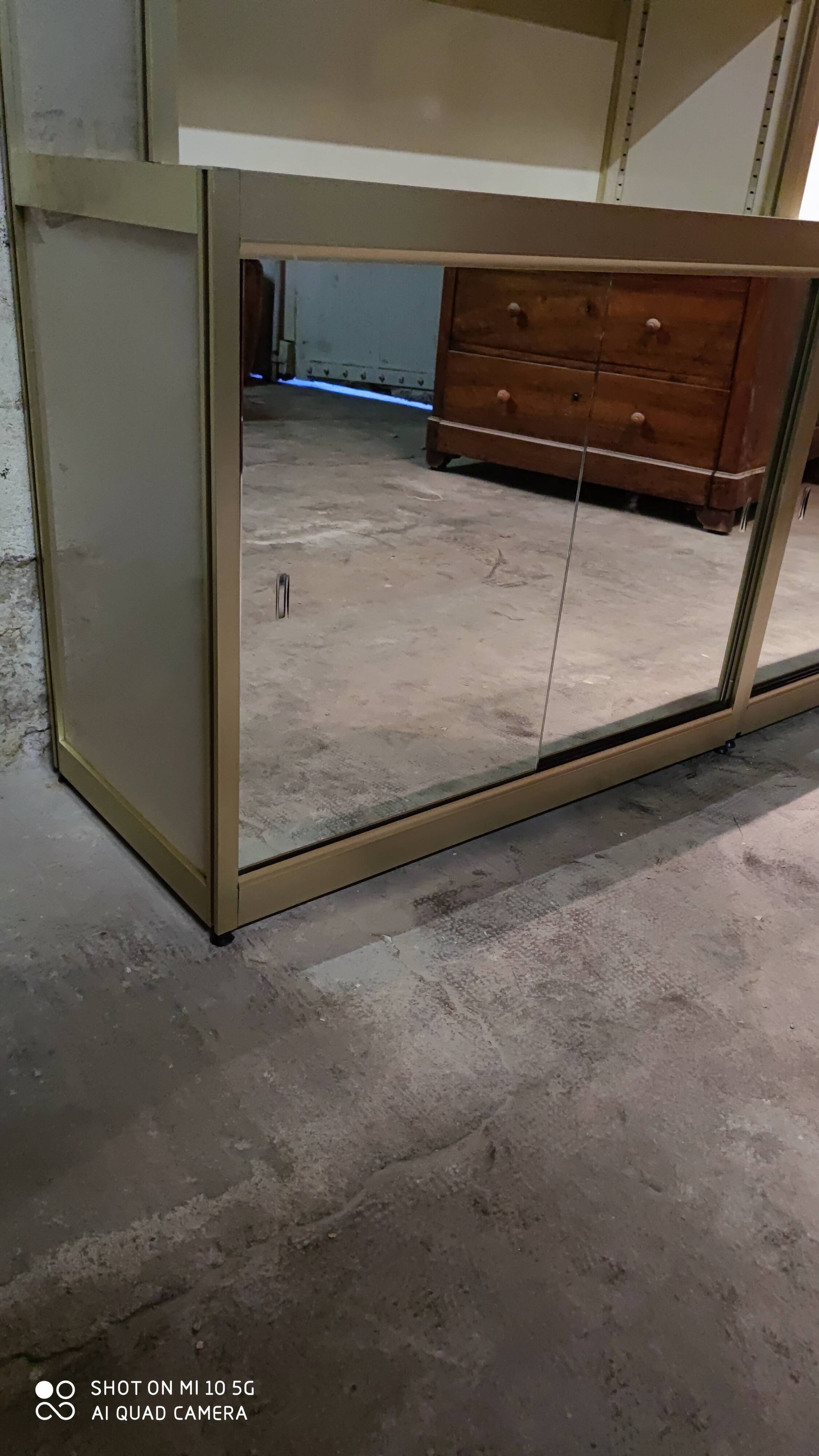 Ivory-colored and matte gold anodized aluminum display bookcase