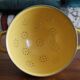 Old yellow enameled colander