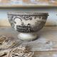Old bowl made of iron with ceramic seams.