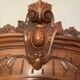 Antique solid wood wardrobe with an oval mirror.