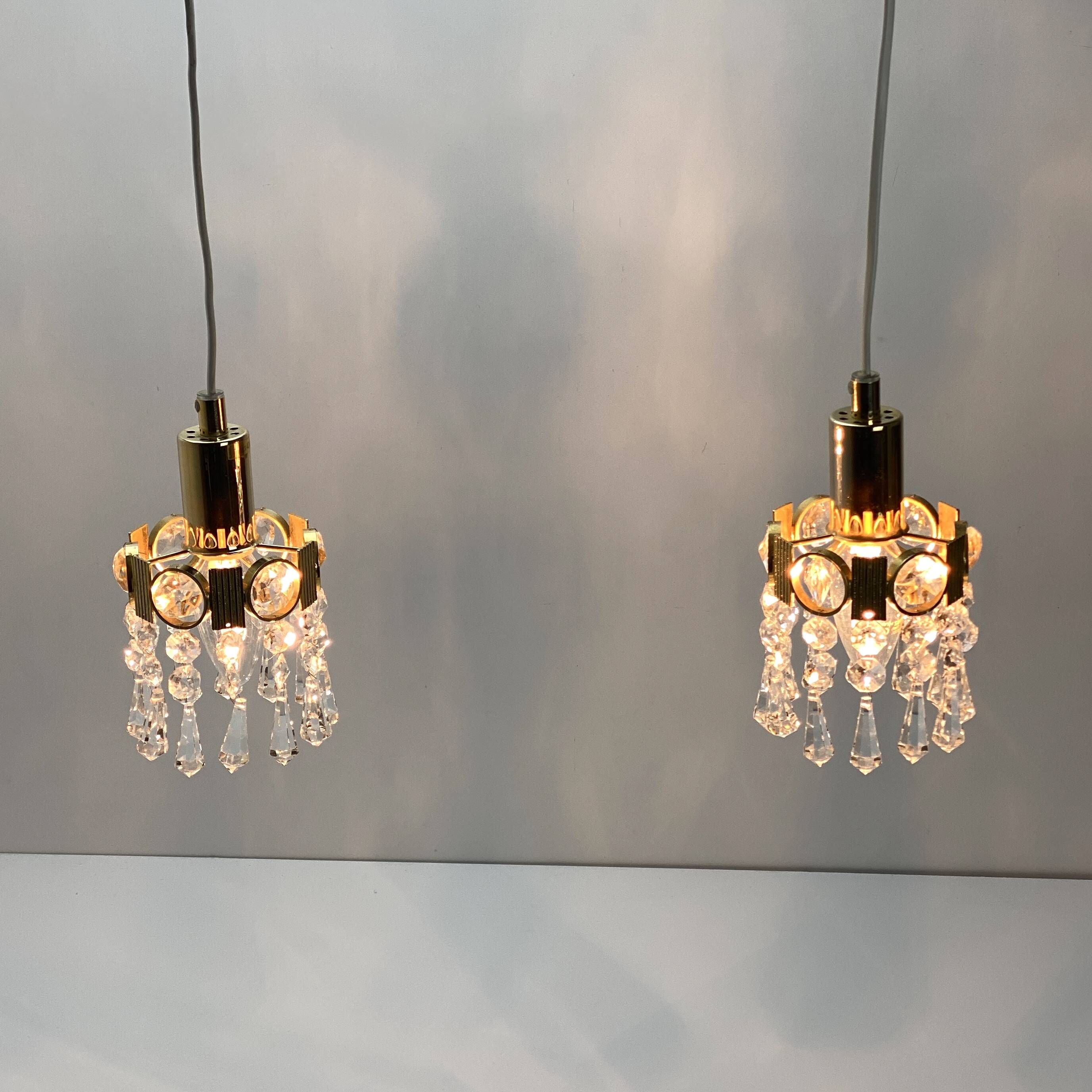 Two gold-plated brass and crystal pendant lights, by Palwa, 1960s design, Hollywood Regency.