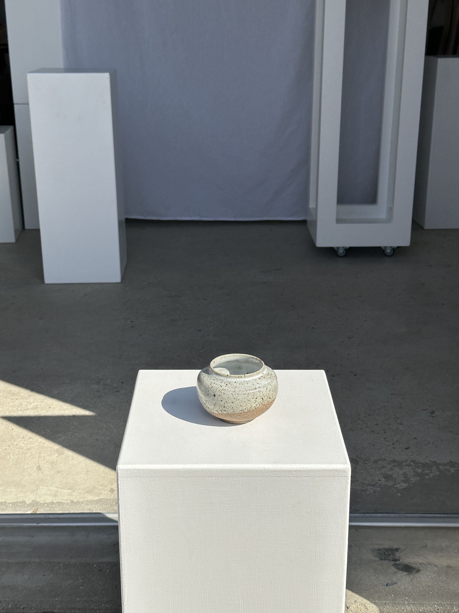 Small white ball vase tight neck in glazed speckled ceramic