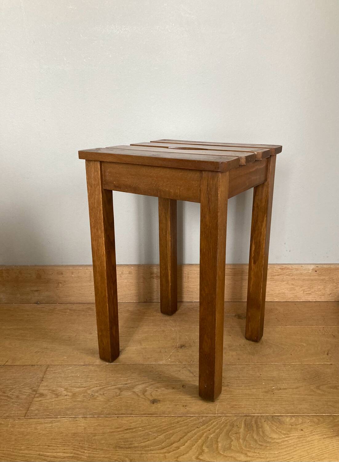 Wooden stool with central grip, quadripod base, 20th century
