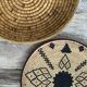 Braided wicker dish with ethnic motifs