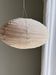Average suspension in natural rattan and linen, Japanese-style, flattened oval in pink.