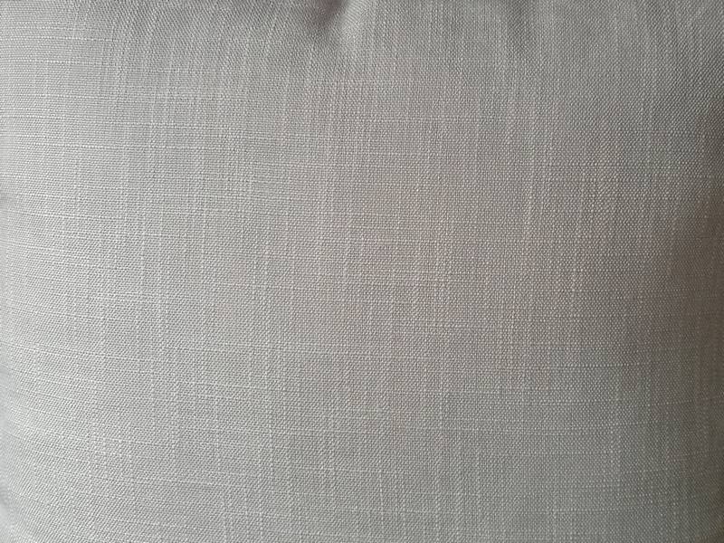 Gray cushion with pompoms