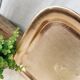 Golden and chiseled brass serving tray