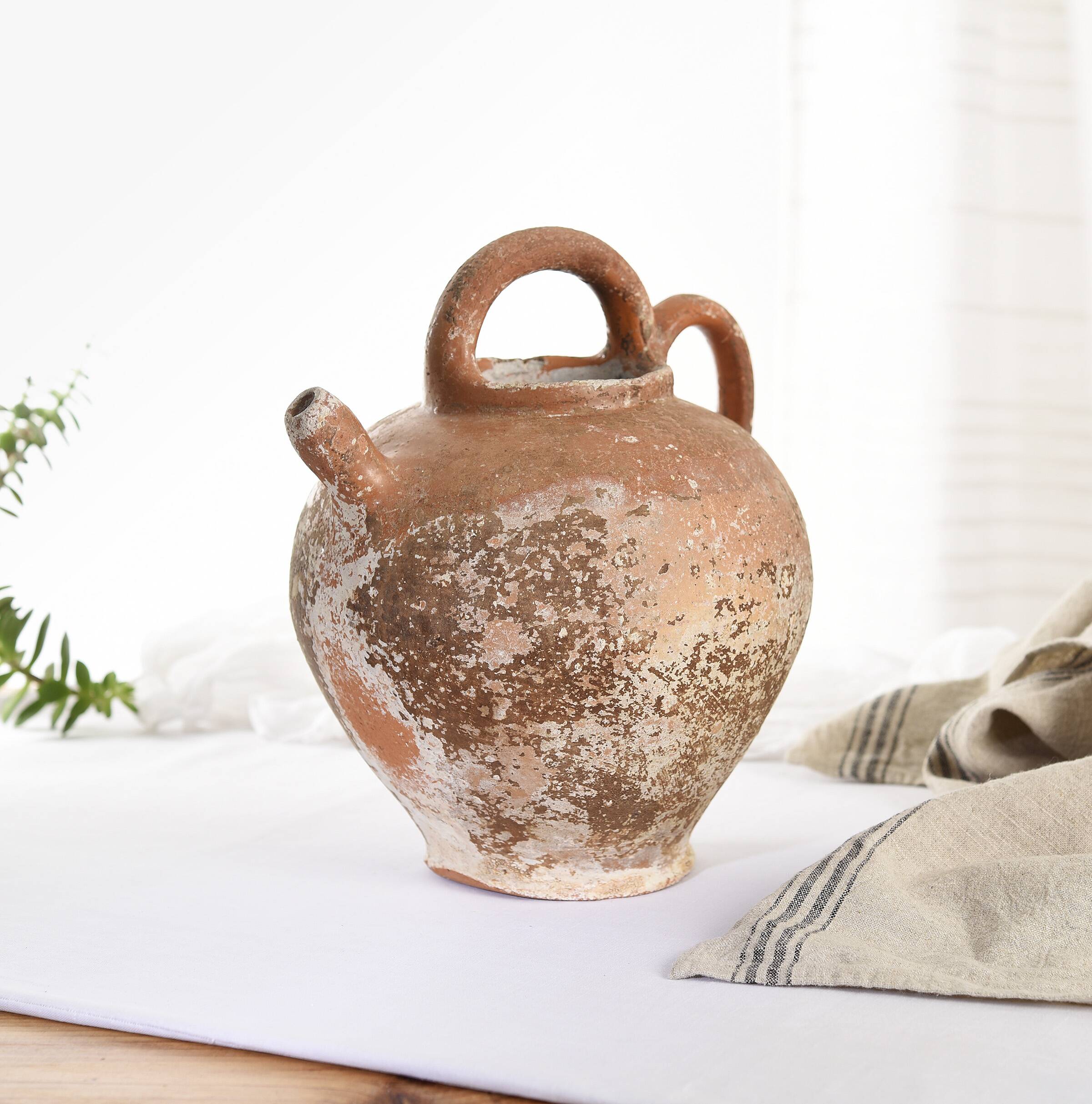 Old water jug. Gargoulette. Old terracotta pitcher.