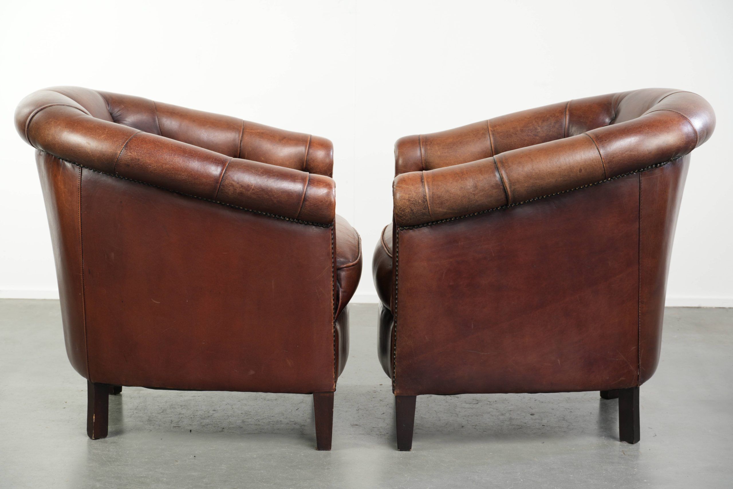 Characterful set of sheepskin club armchairs in English chesterfield style
