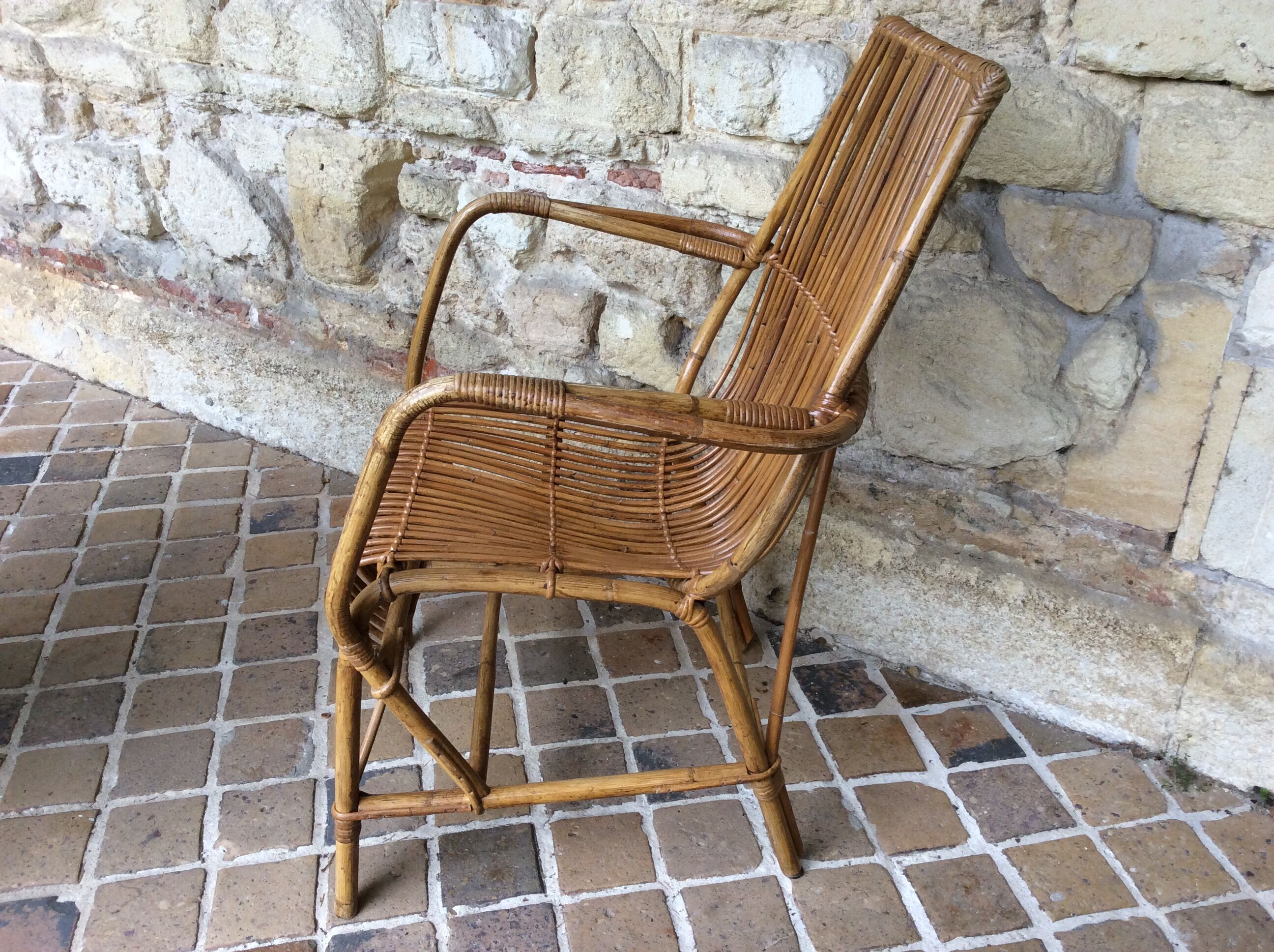 Rattan armchair and his feet rest