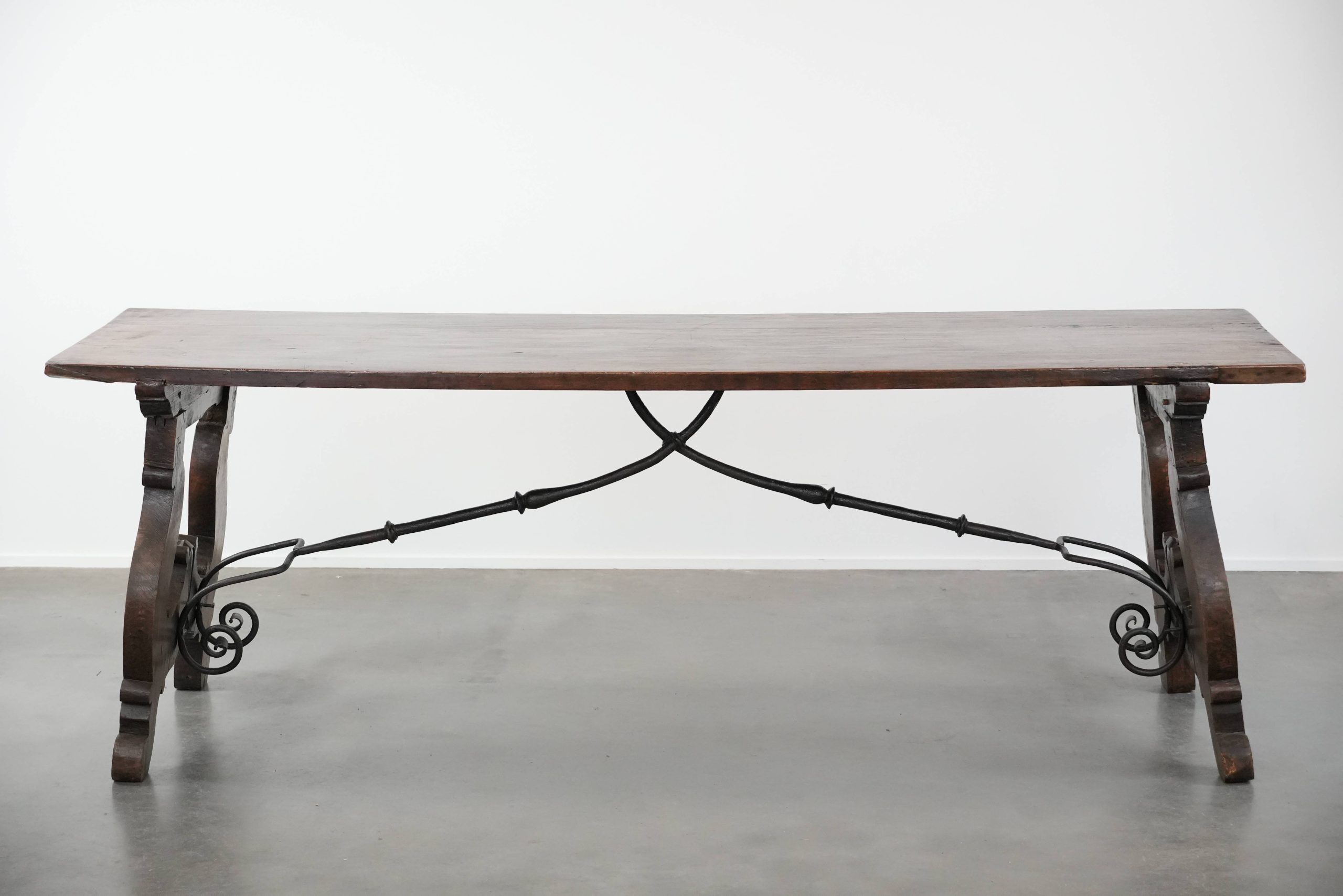 Antique 18th-century Spanish dining table with a wrought iron base