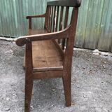 Duo of old solid oak benches with backs and armrests.