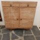 Vintage woven rattan furniture with tapered legs.