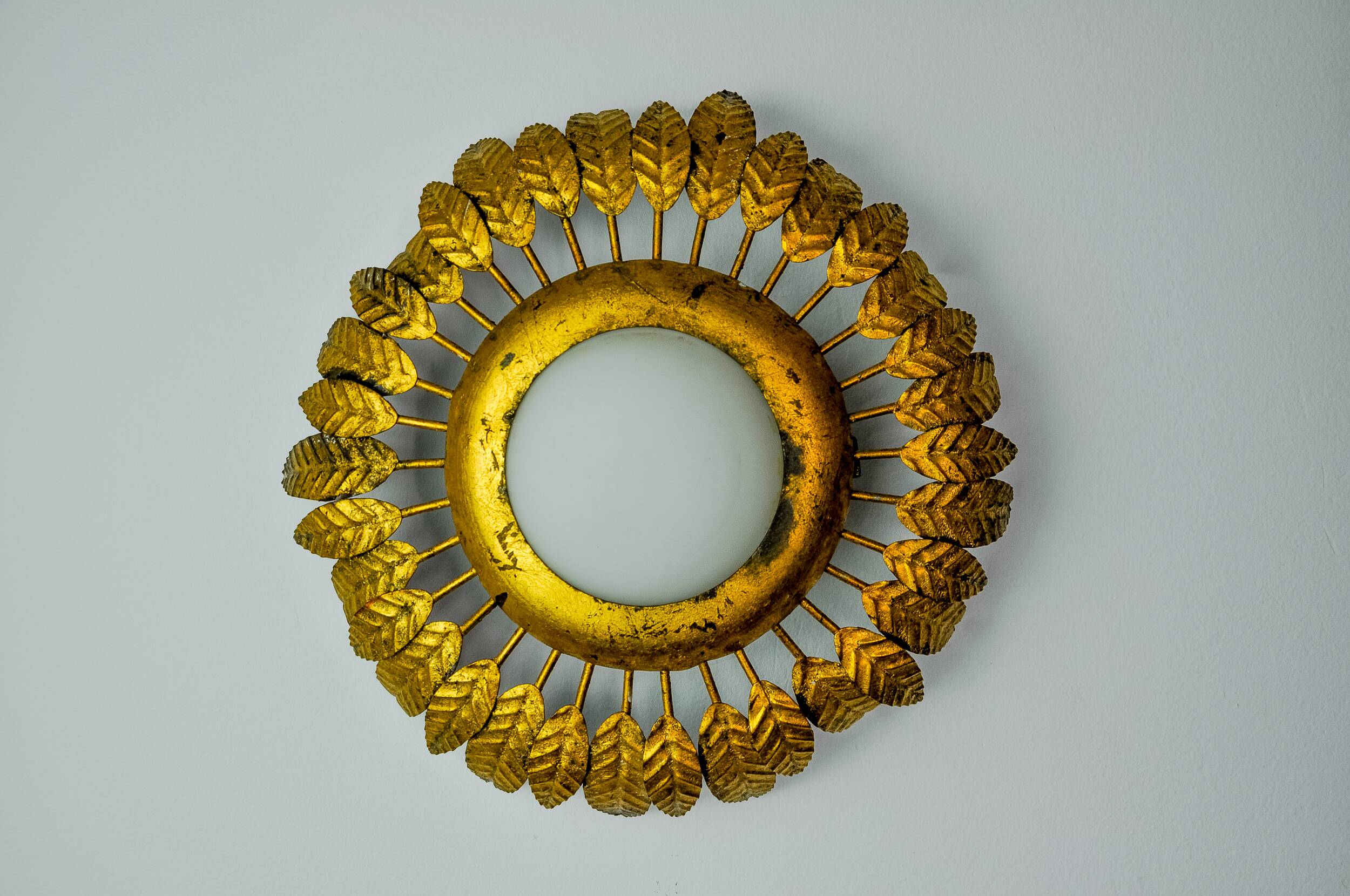 Sun wall lamp by ferro arte, metal and gold leaf and opaline glass, Spain, 1960