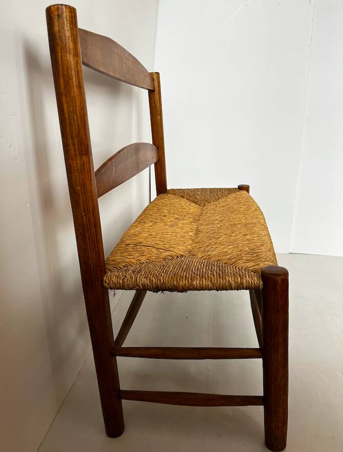 Old wooden and straw bench