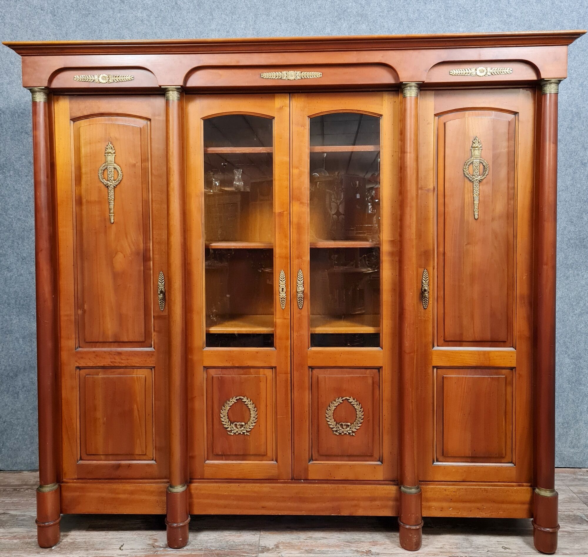 Empire library in cherry tree with blonde patina and gilded bronze around 1950