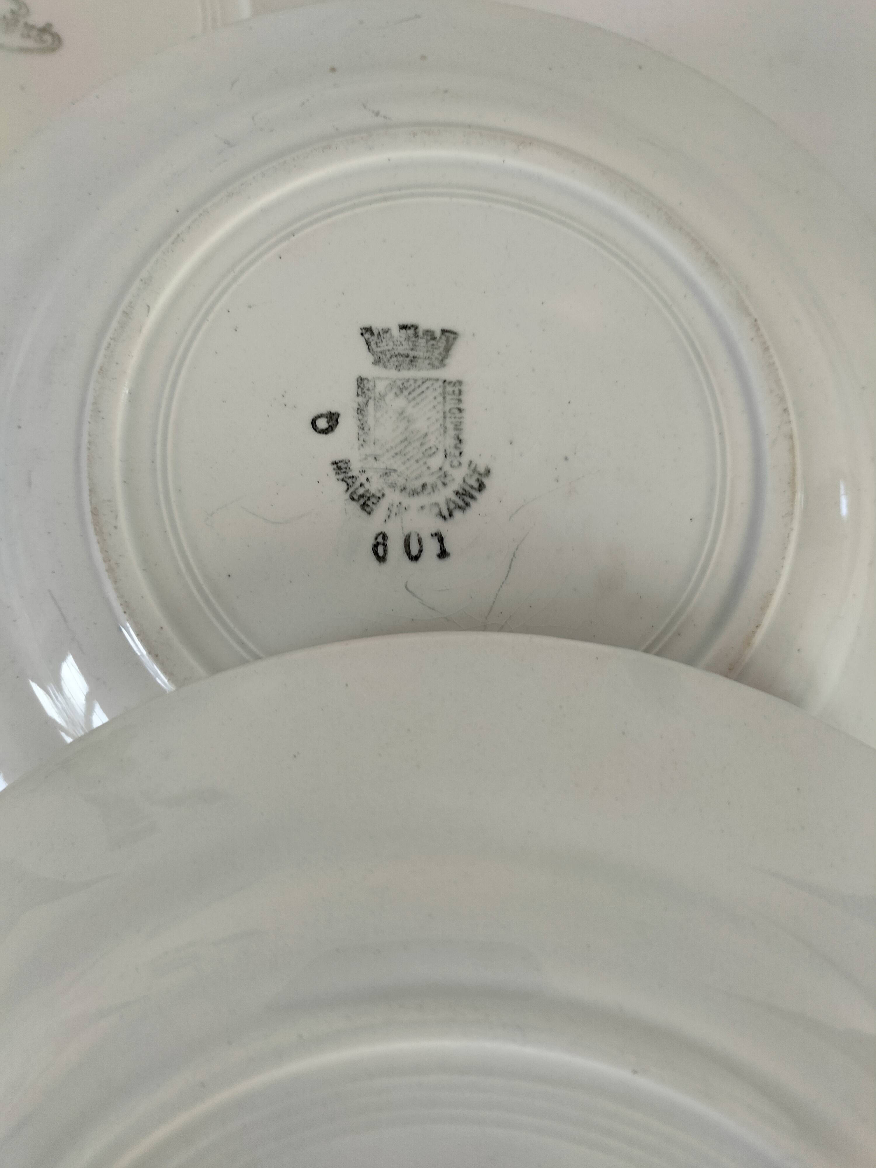 Set of 8 ironstone plates with coordinated designs.