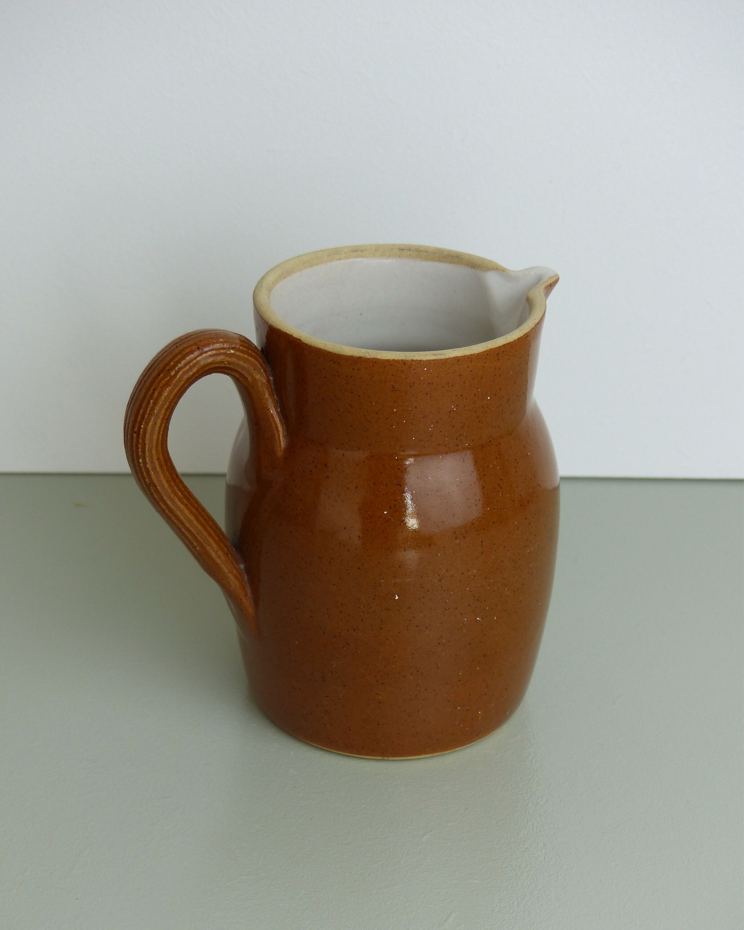Pitcher or milk pot in speckled enamelled sandstone