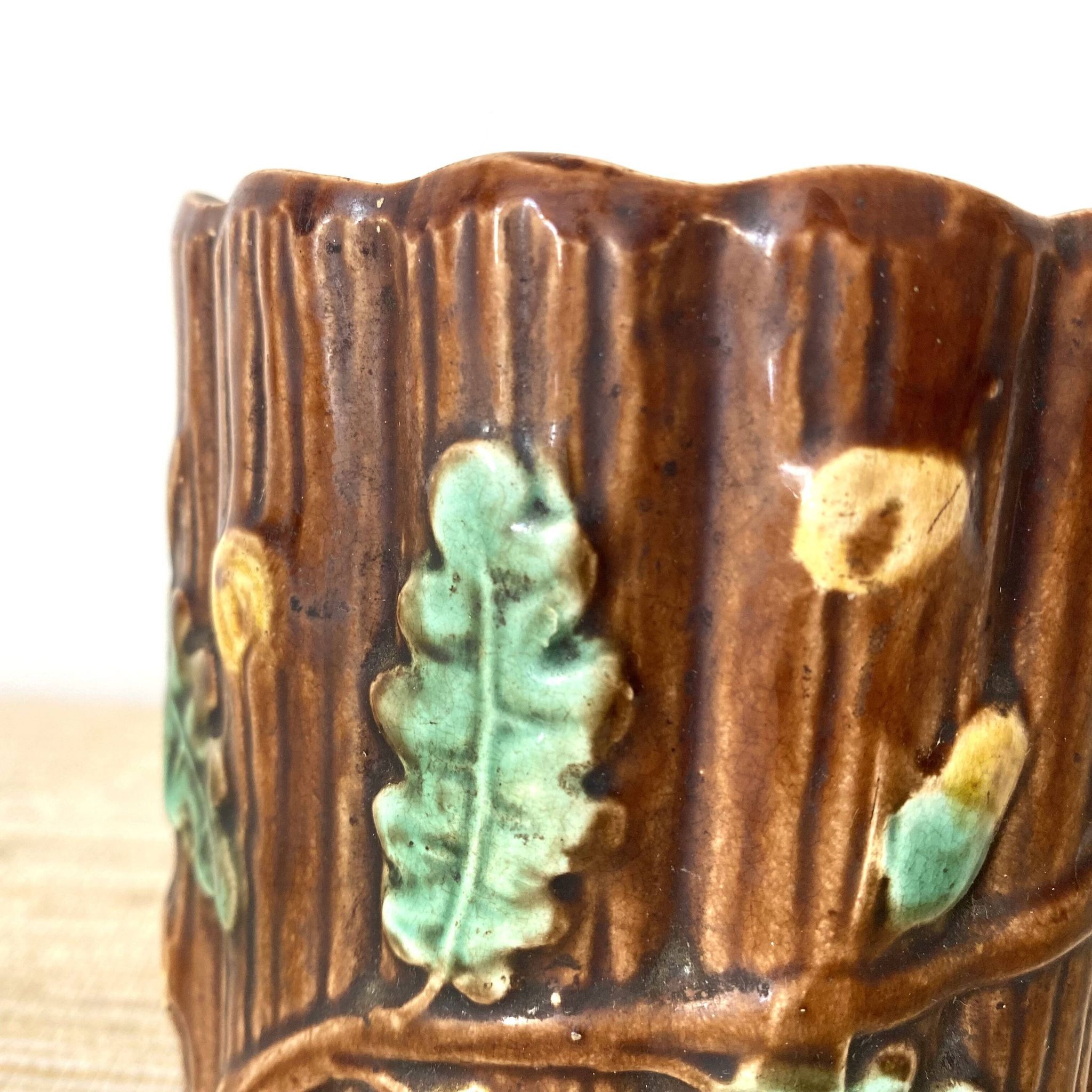 Antique slip pot with acorn decoration