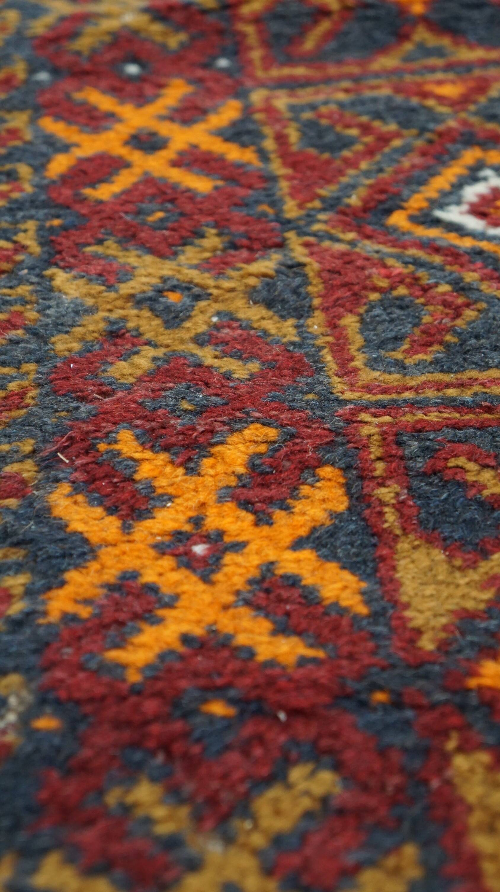 Antique oriental rug featuring orange details 135x81cm