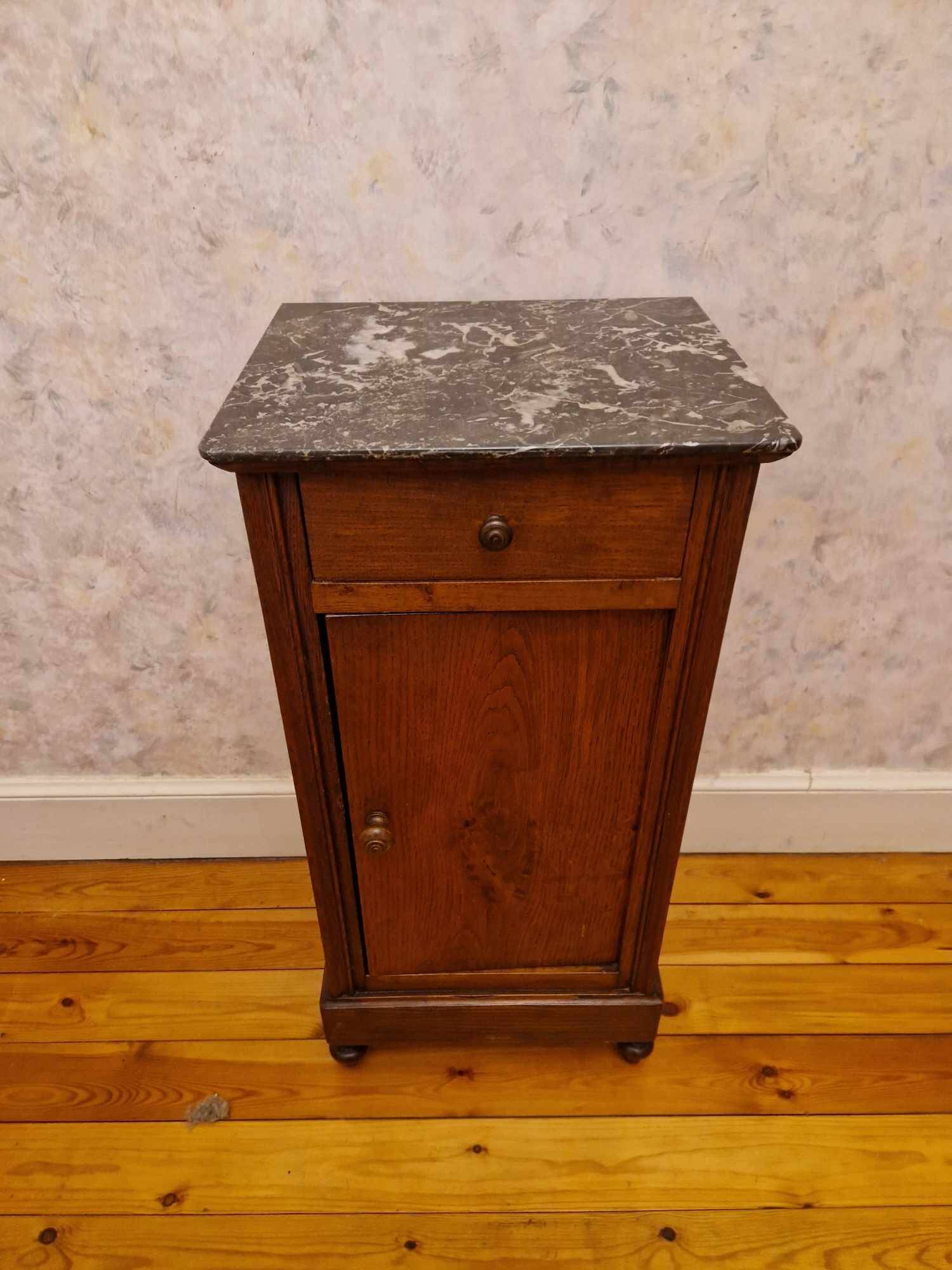 Antique wooden bedside table with black marble top