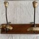 19th-century wall coat rack with 2 metal and horn hooks.