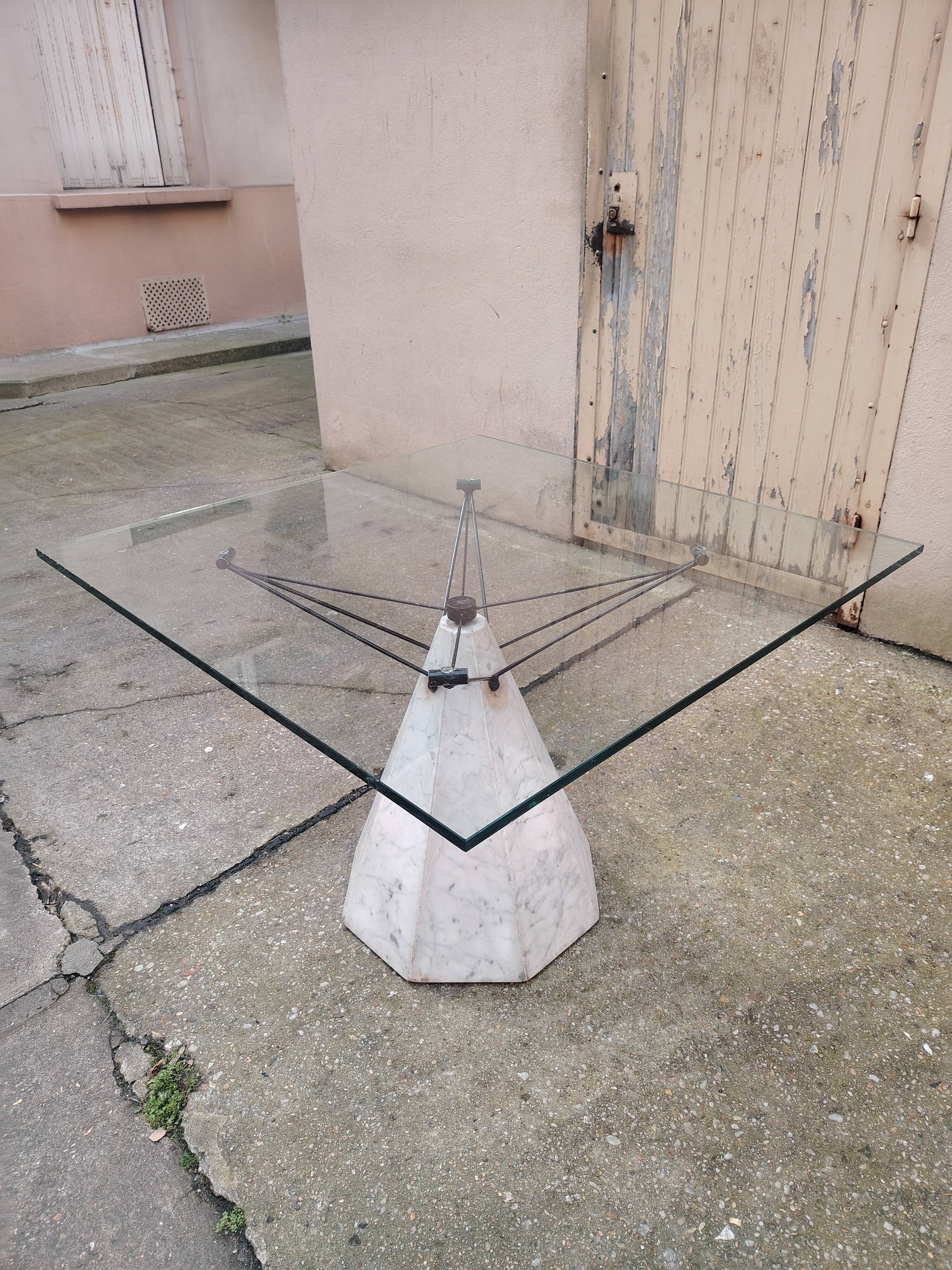1980s table with a marble and steel base and a square glass top.