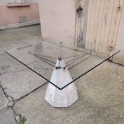 1980s table with a marble and steel base and a square glass top.
